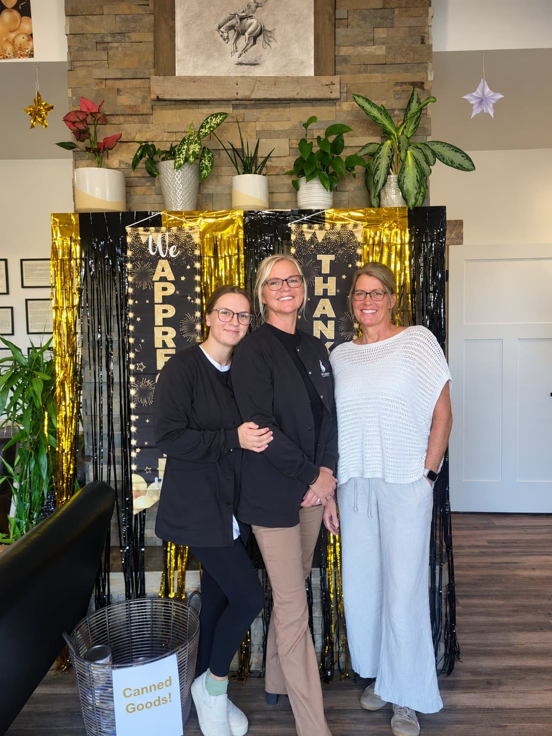 Three clinic team members smiling at an appreciation event